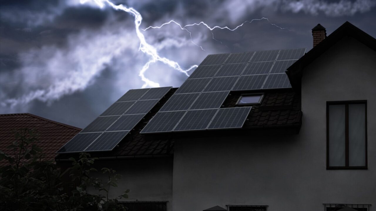 Dark cloudy sky with lightning over house in a stormy weather