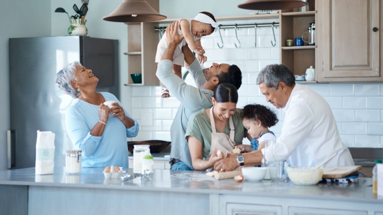 A multigenerational family baking together in the kitchen.