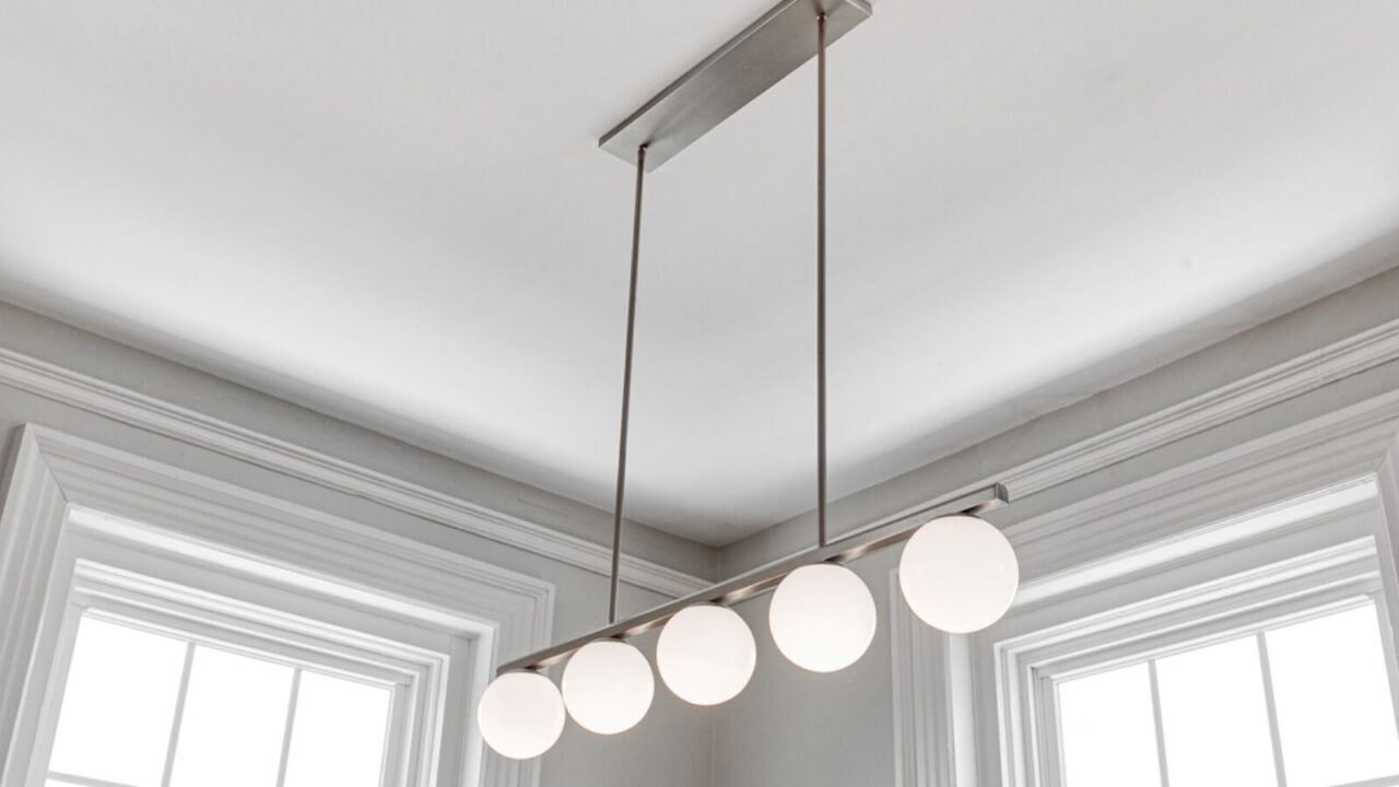 A linear pendant chandelier hanging from the ceiling.