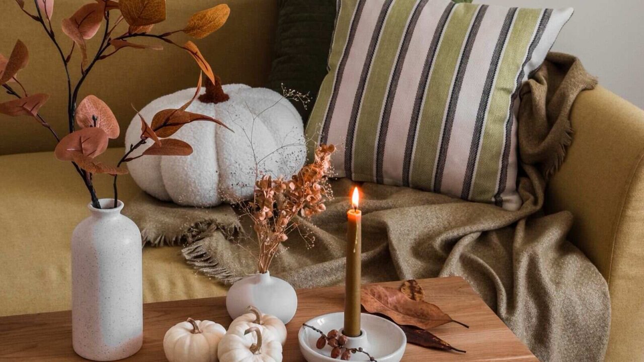 Autumn interior of the living room sofa with pillows and blankets.