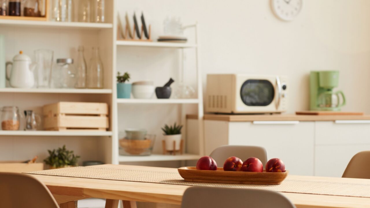 Kitchen with wooden table, chairs, and shelves