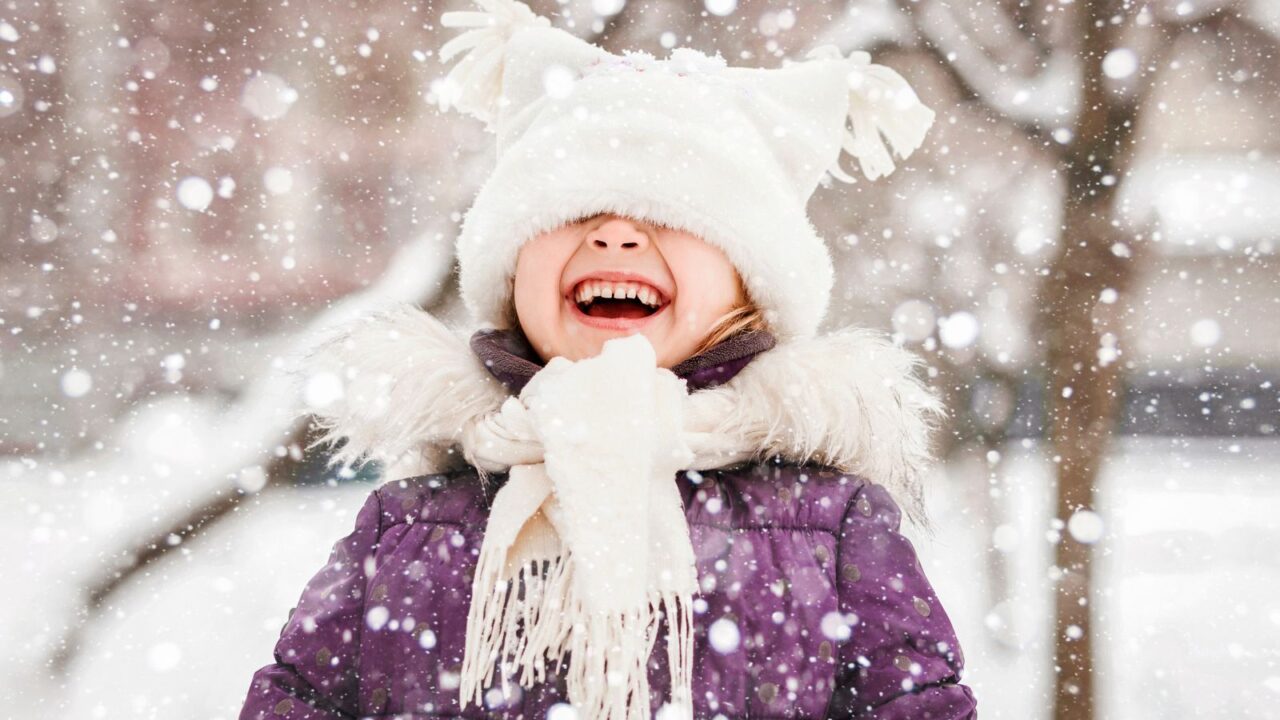 A little girl smiling in snow