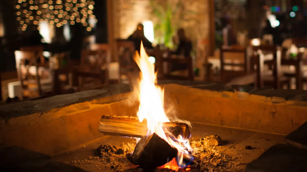 Cosy fireplace in a mountain chalet's warm, wooden interior