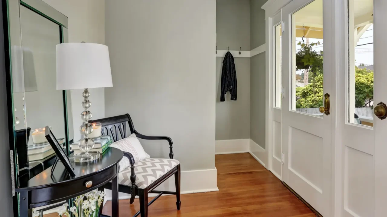 Entryway with gray walls, console table and wood floors