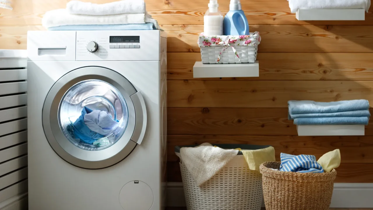 Interior of real laundry room with washing machine at window at