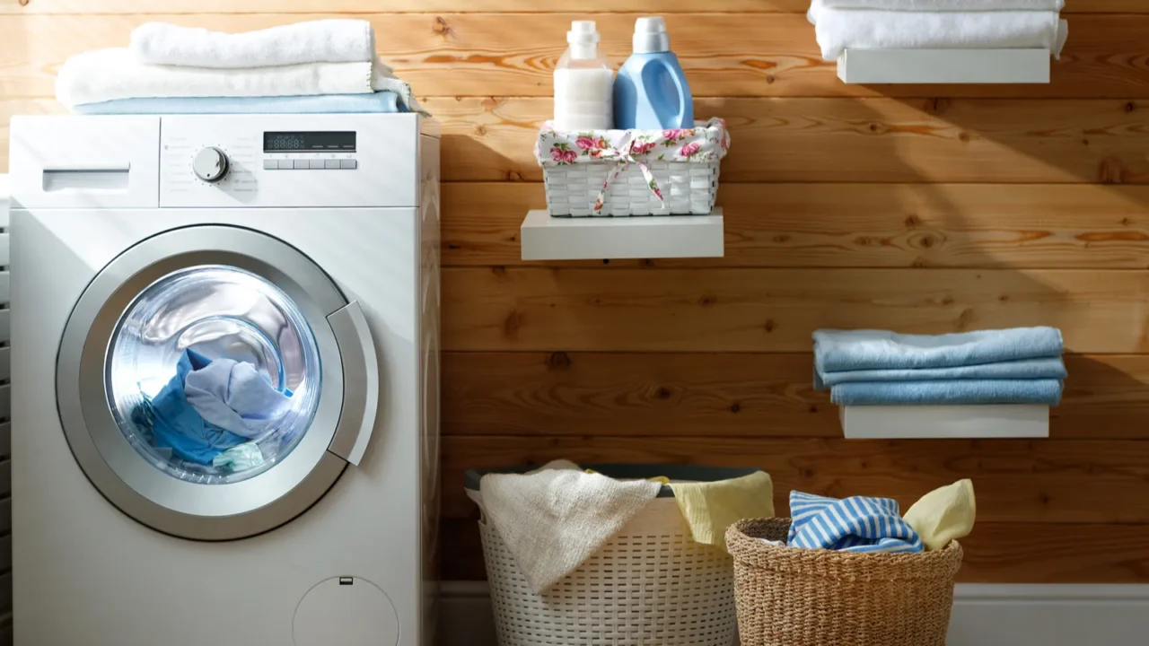 Interior of real laundry room with washing machine at window at