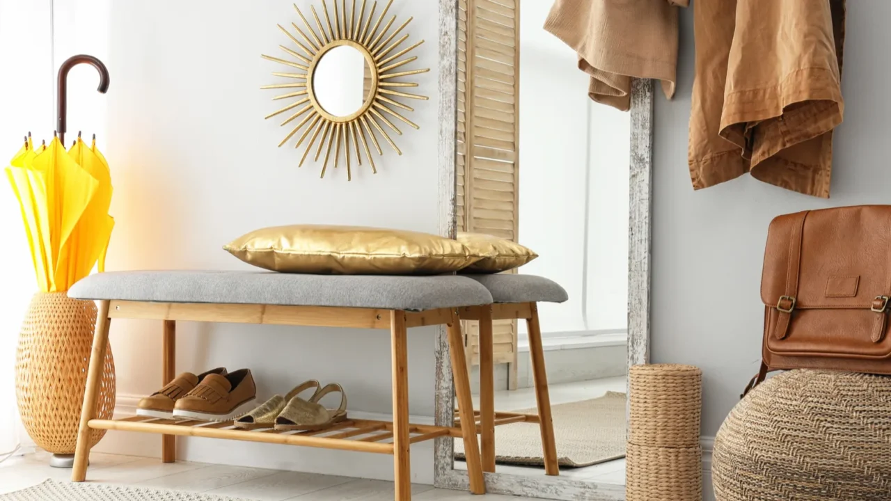 Stylish hallway interior with large mirror and storage bench near light wall