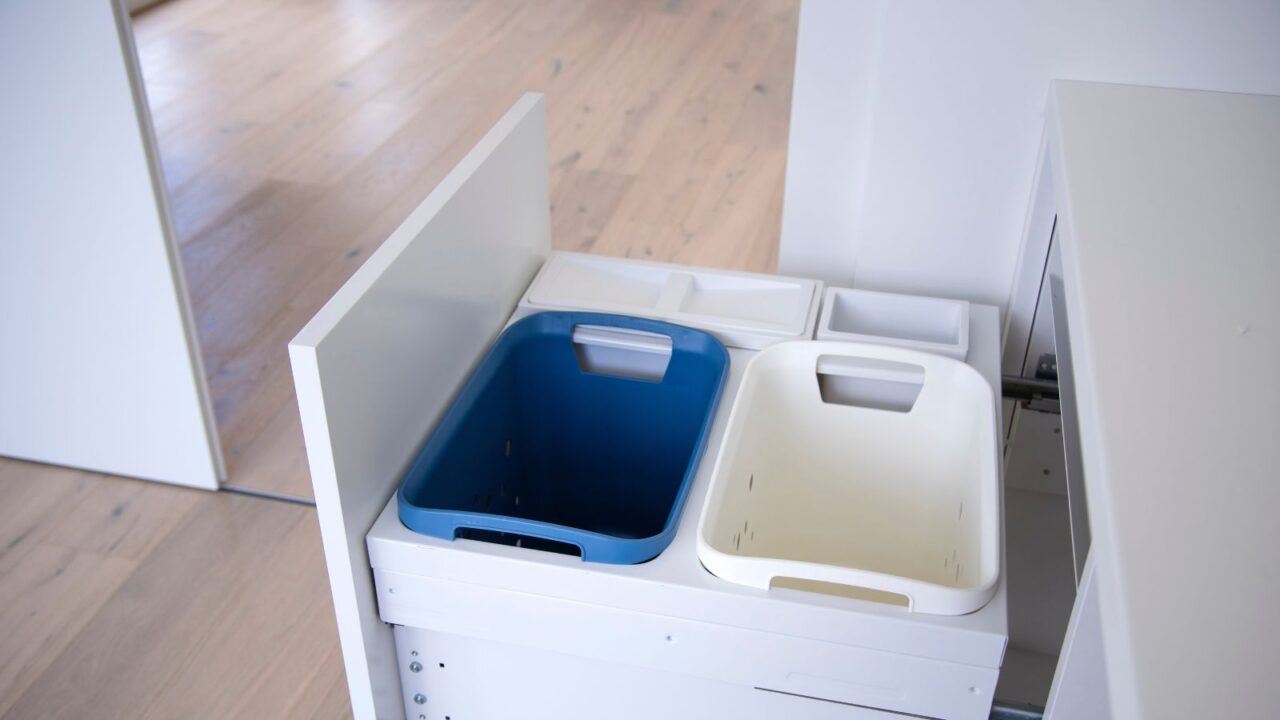 Modern pull-out bins in the kitchen under the counter.