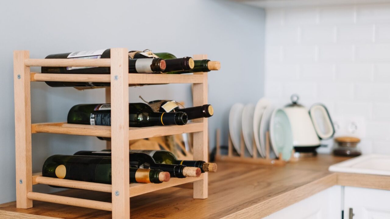 Wooden wine rack on kitchen counter for keeping the space organized and clean.