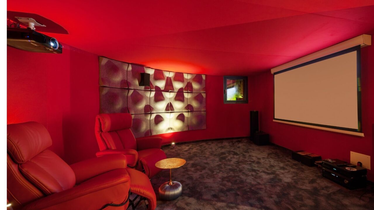 A red home theater interior with projector and red recliners