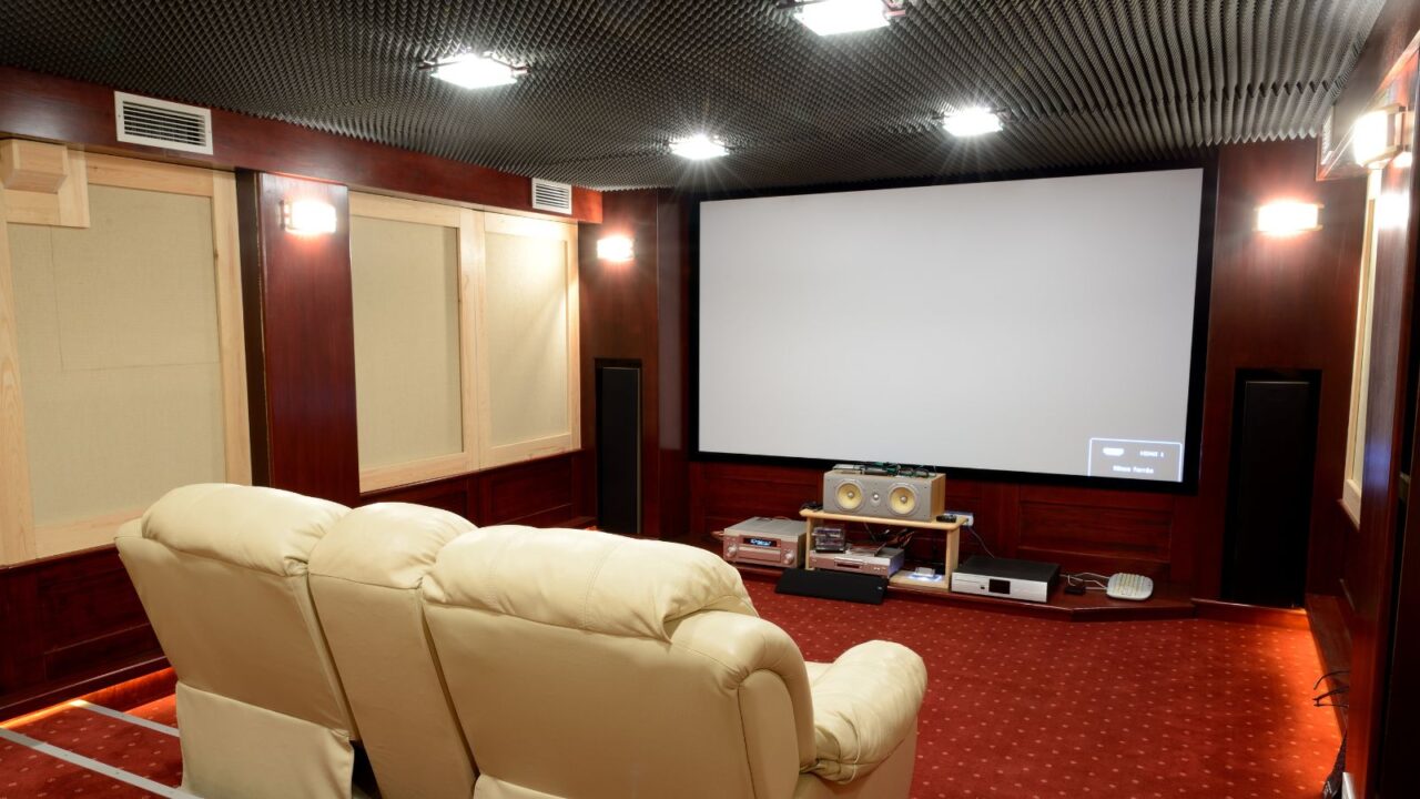 Home theatre setup with acoustic panels, sound system and projector