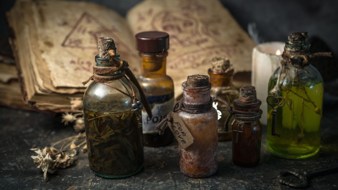 Halloween decor with potion bottles with magic book in the background