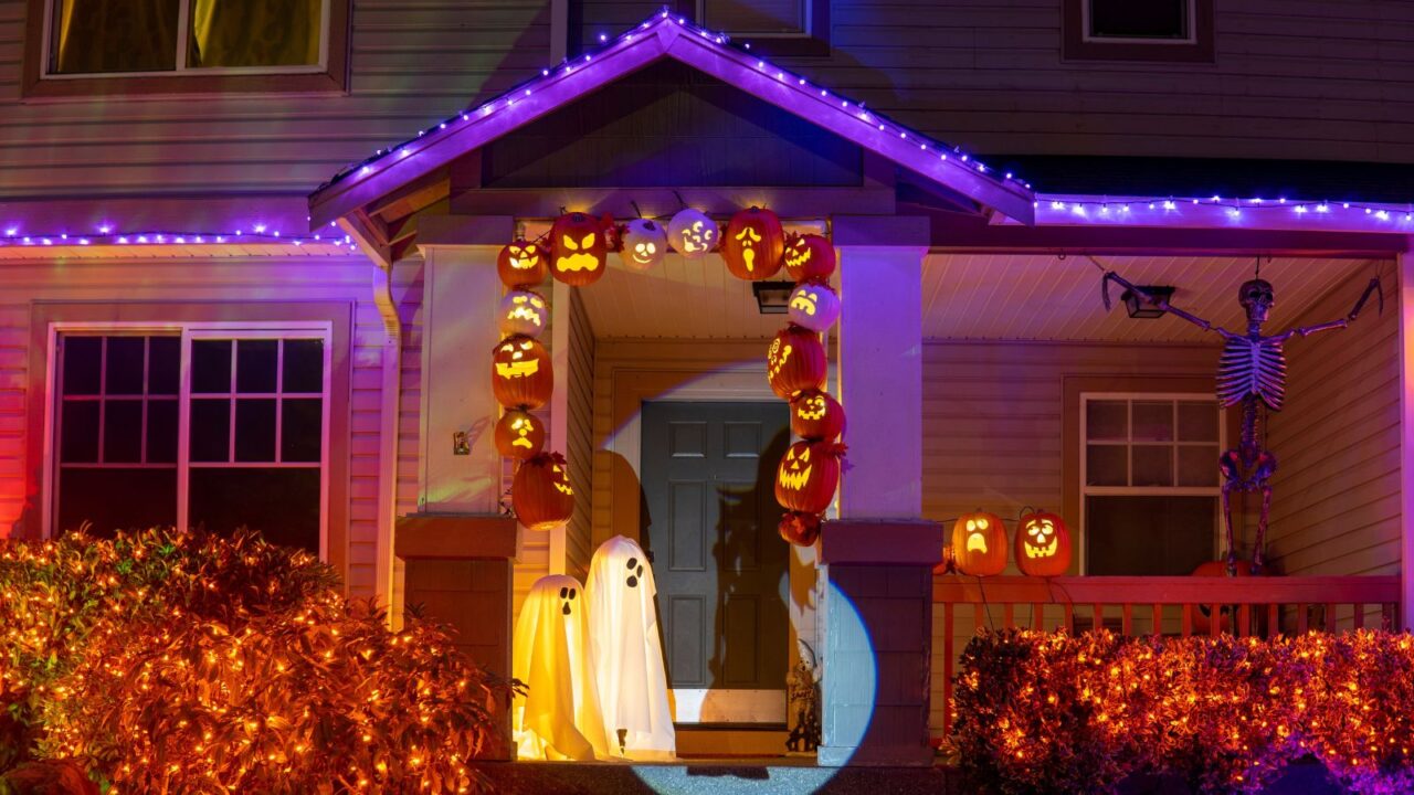 Halloween decor with pumpkins, skeletons and ghosts outside the house