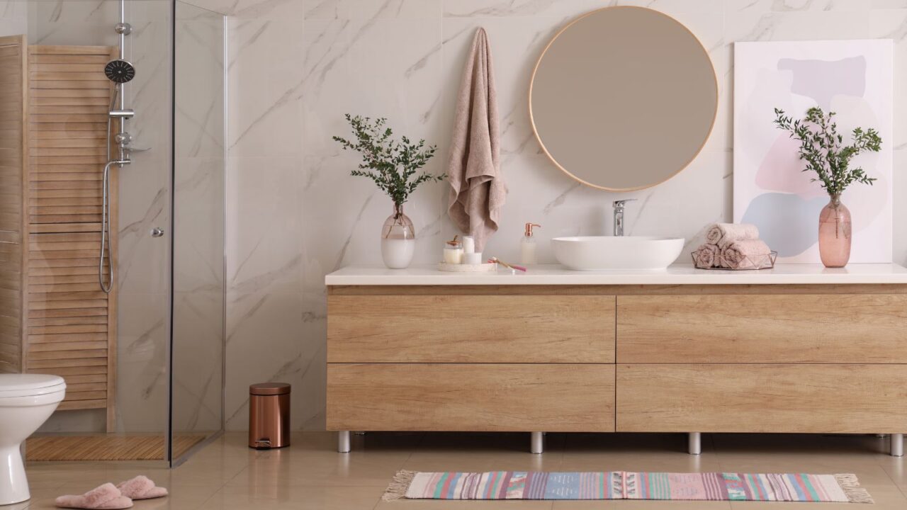 Modern bathroom interior with stylish mirror and vessel sink.