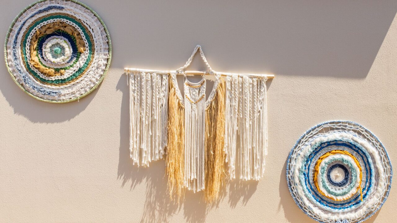 Hanging Macrame Tapestry Boho handcrafted decorations. Stylish boho Macrame wall hanging on beige background - vintage retro style.