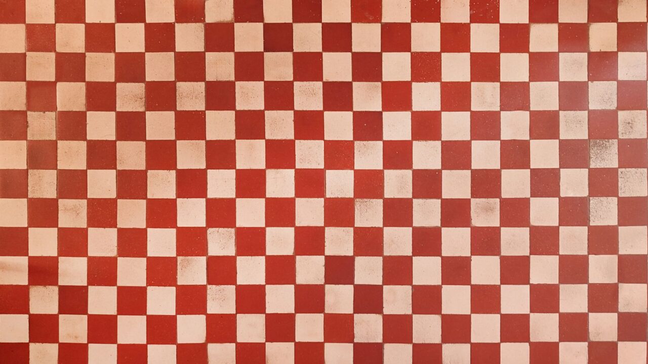 Original 1970s retro wall tiles. Square white and red checkered tiles. Vintage style home decor.