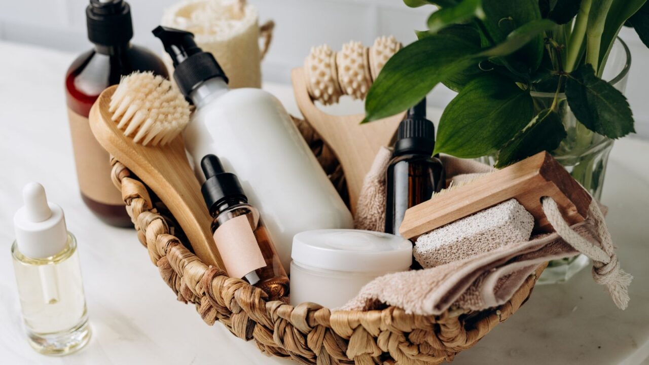 A woven basket with skin care products and bathroom accessories