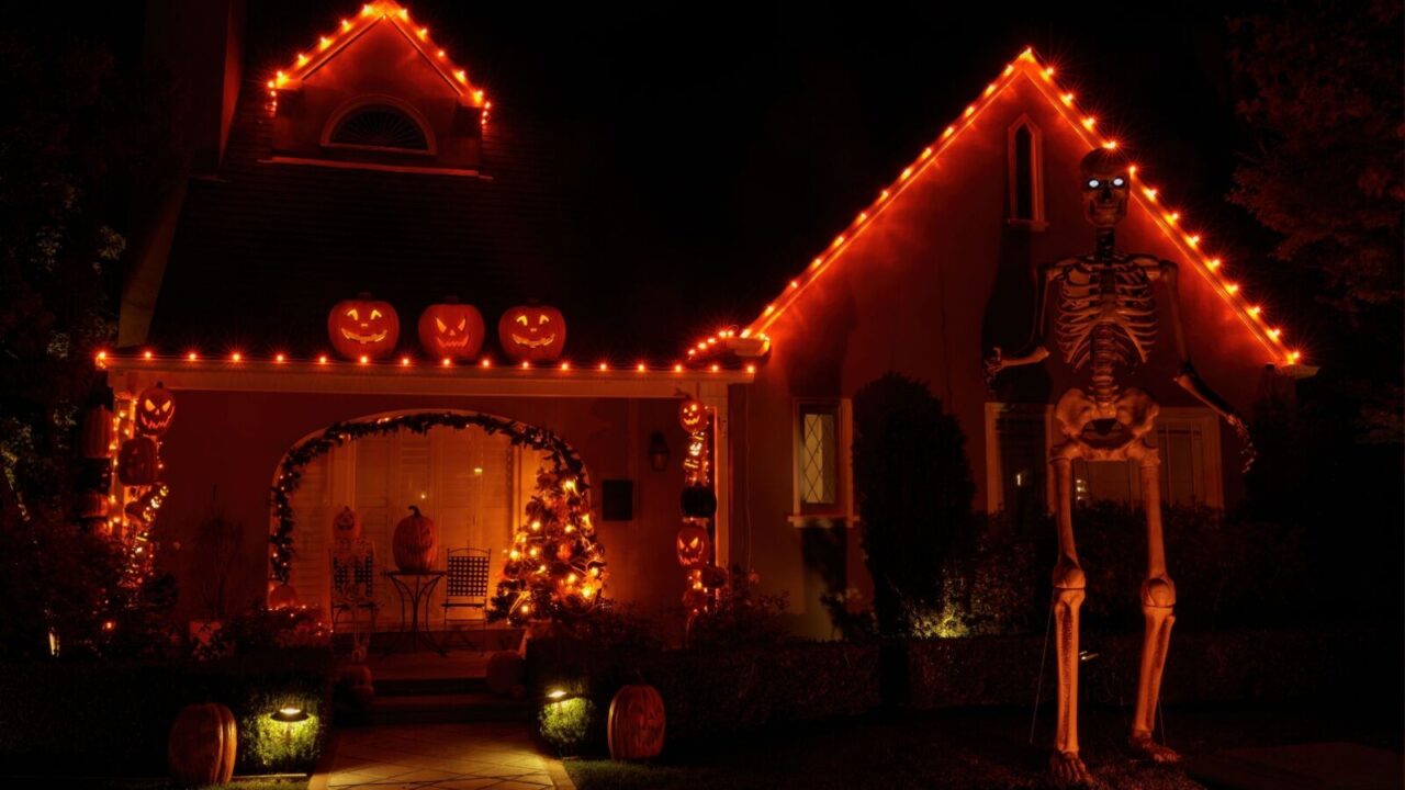 Halloween decorated with Halloween lights and ornaments like pumpkins and skeleton at night