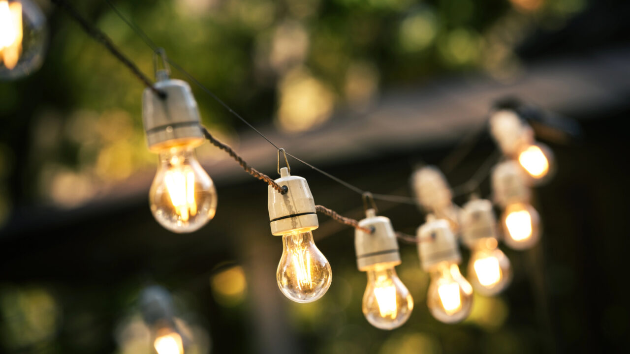 outdoor string lights hanging on a line in backyard