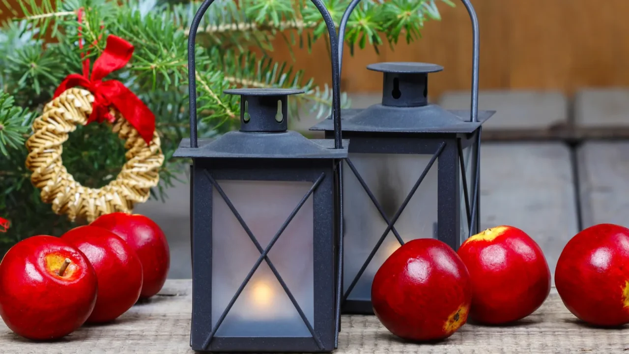 Beautiful christmas setting: lanterns, apples, christmas tree