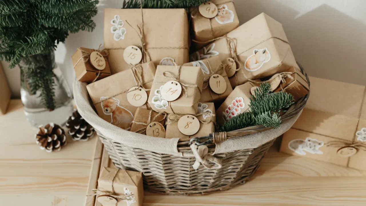 Christmas Advent calendar for kids. Basket with advent gifts boxes with numbers for children standing on wooden cabinet. Eco friendly christmas