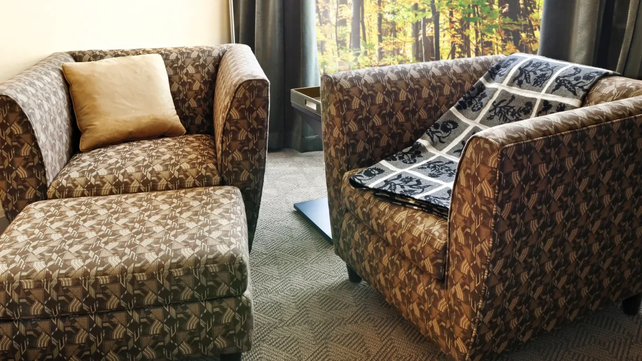 Comfortable armchairs with cushion and ottoman. Photo on the wall is my own.