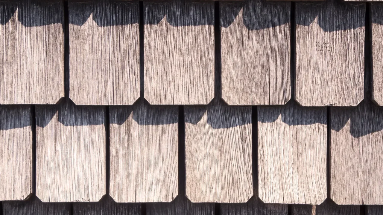 Full-frame view of weathered roof shingles.