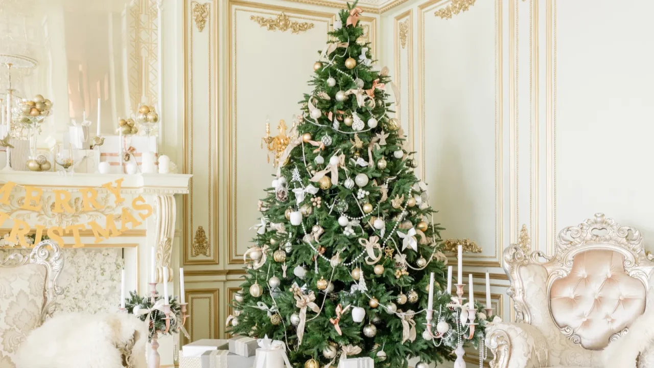 Luxury apartment decorated for christmas. Xmas tree with presents underneath in living room