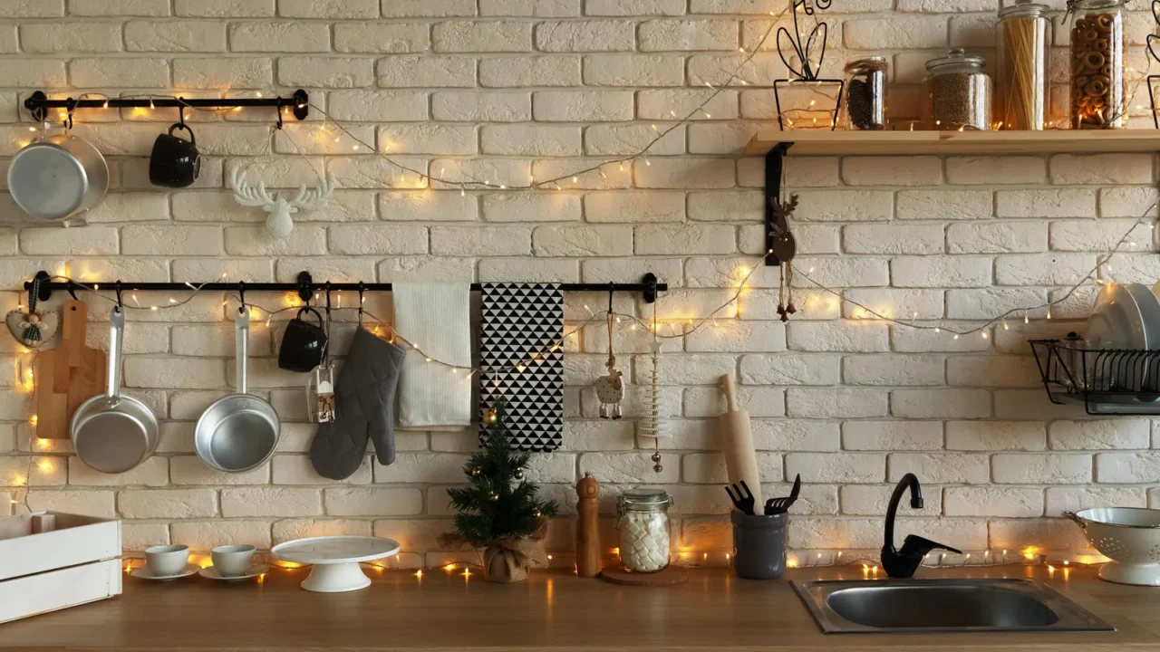 New Year and Christmas 2018. Festive kitchen in Christmas decorations. Candles, spruce branches, wooden stands, table laying.