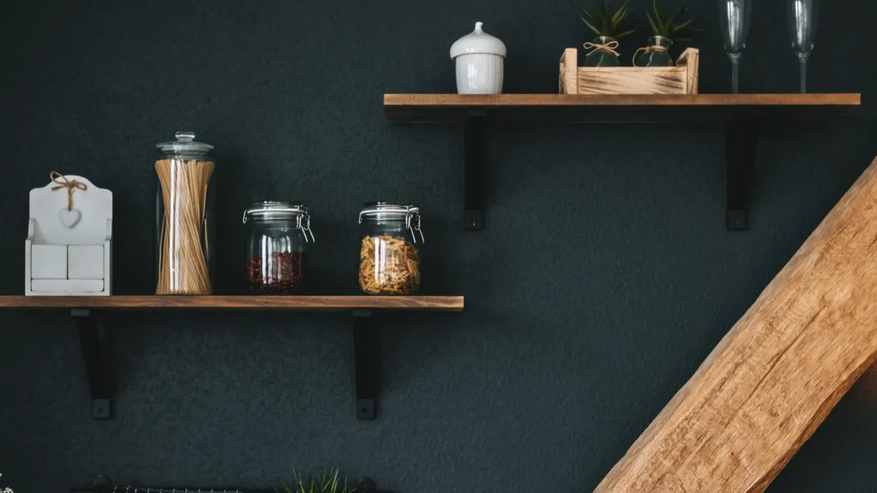 Pasta and grocery in glass jars on a wooden shelf in the kitchen. Detail. High quality photo