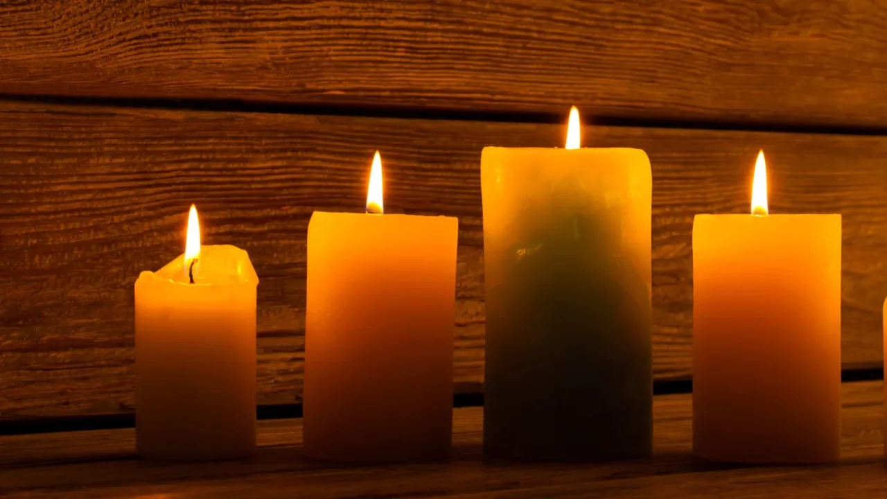 Row of pillar candles in different sizes.