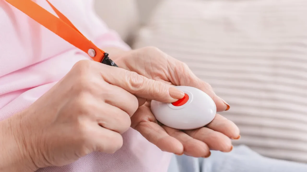 Senior woman hand pressing Alarm Button, closeup