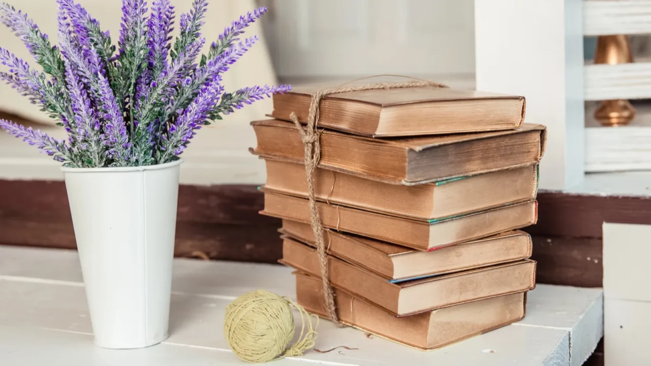 Shabby chic style. decoration with vintage books and lavender.Shabby chic interior decor for farmhouse. Lavender in pitcher, books.Provence home decoration.