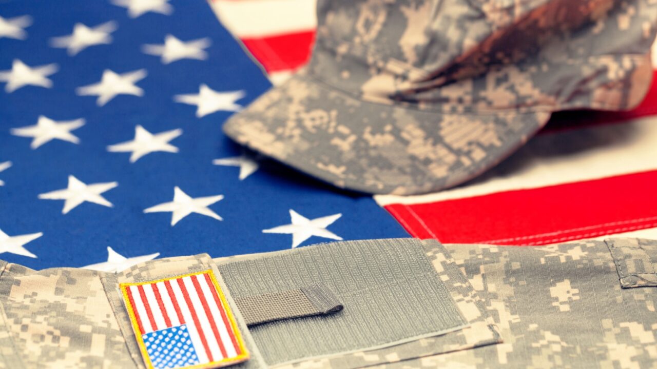 Shutterstock, US flag with US military uniform over it, Niyazz_650079319