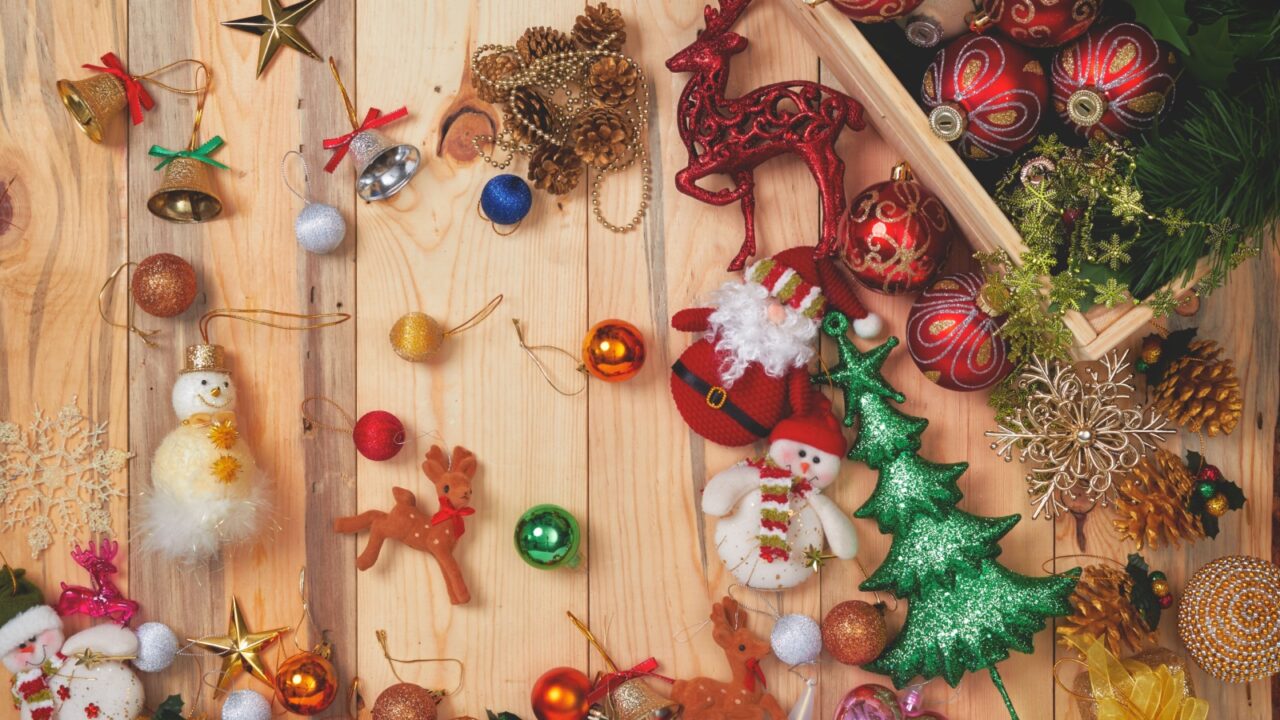 Small Christmas ornaments on a wooden table.