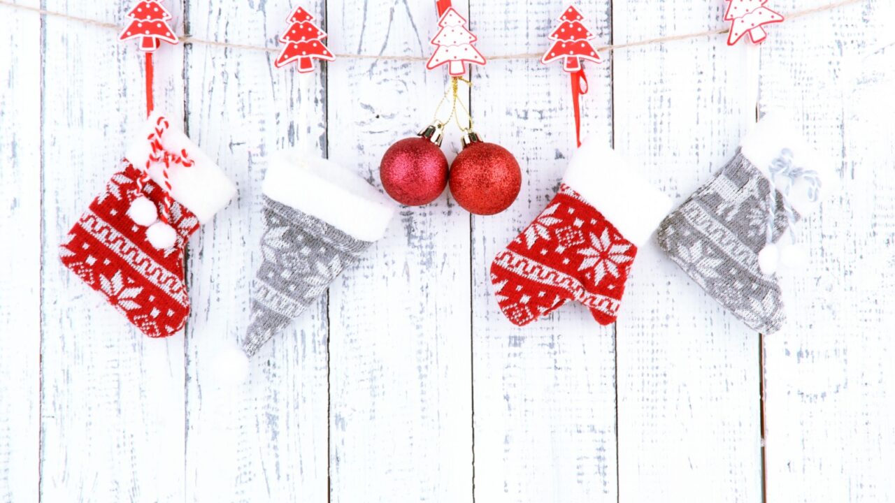 Christmas accessories hanging on white wooden wall