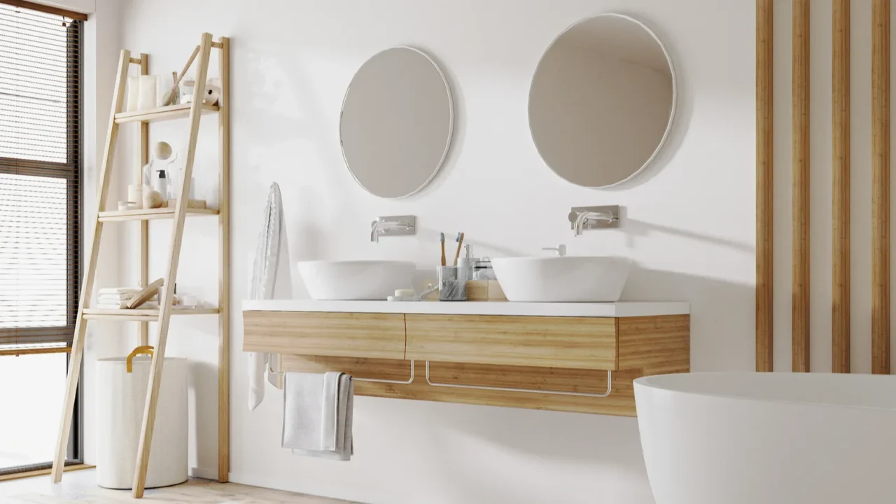 Stylish bathroom interior with modern tub, wooden ladder with bath accessories and beautiful decor, double sinks and mirrors, home design.