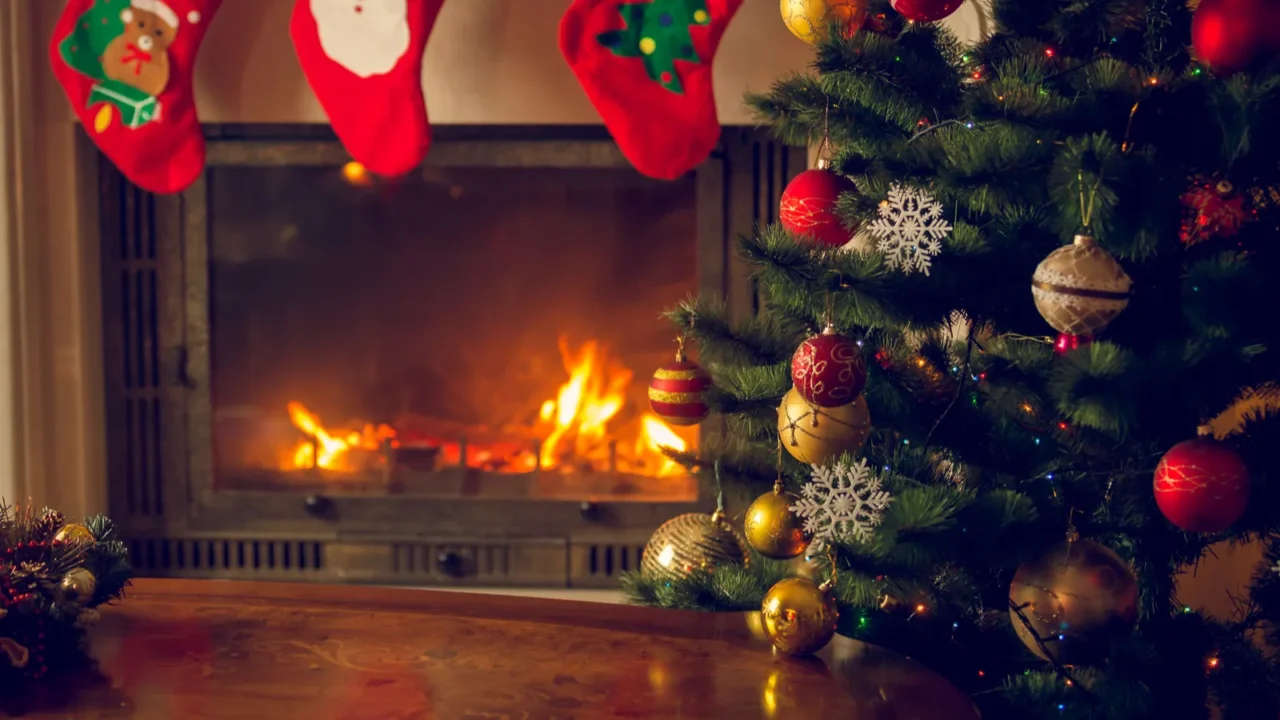 Toned image of wooden table in front of decorated fireplace and