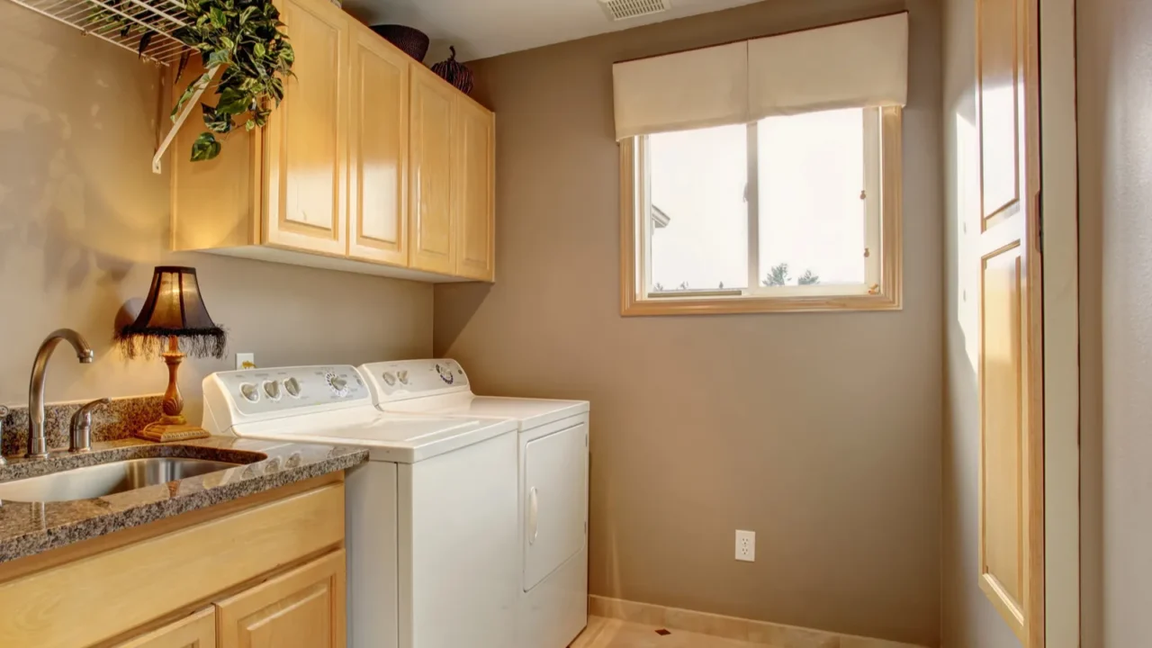 Traditional laundry room with nice counters and washer dryer com