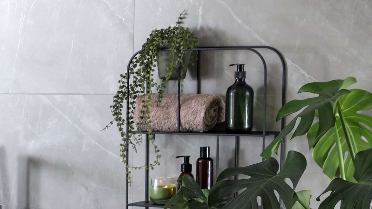 Modern white tub and beautiful green houseplants in bathroom. Interior design.