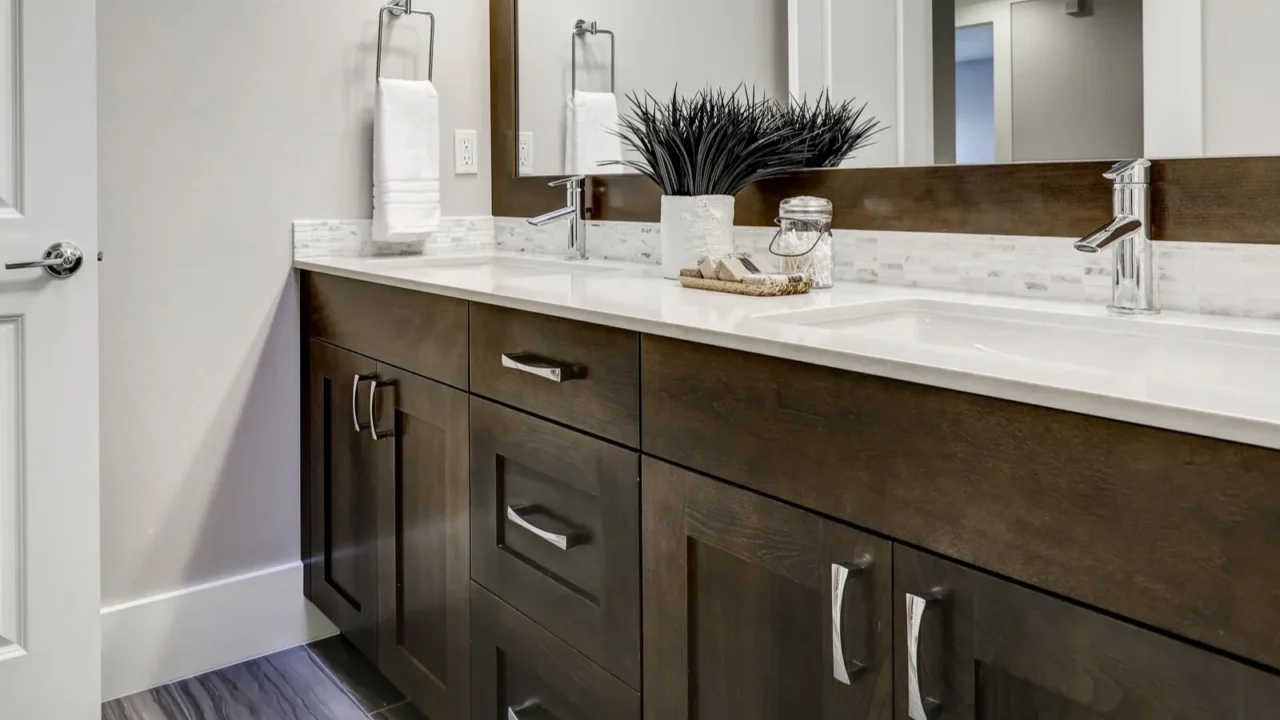 White and brown bathroom boasts a nook filled with double vanity