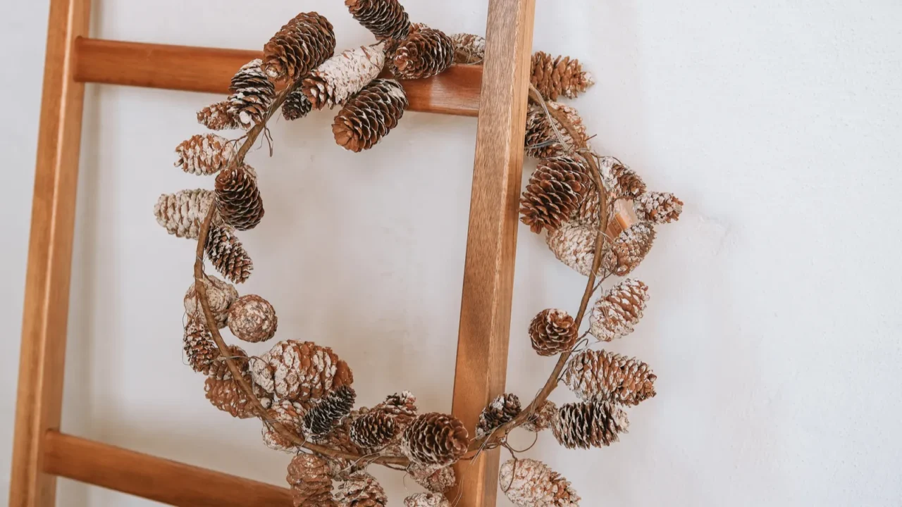 a beautiful wreath made of pinecones is elegantly hanging on