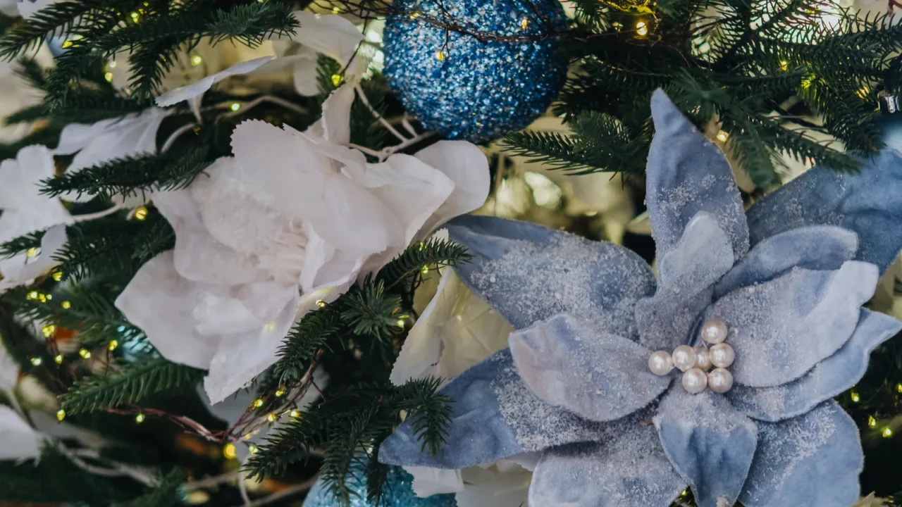 a beautifully decorated christmas tree features intricate blue ornaments and