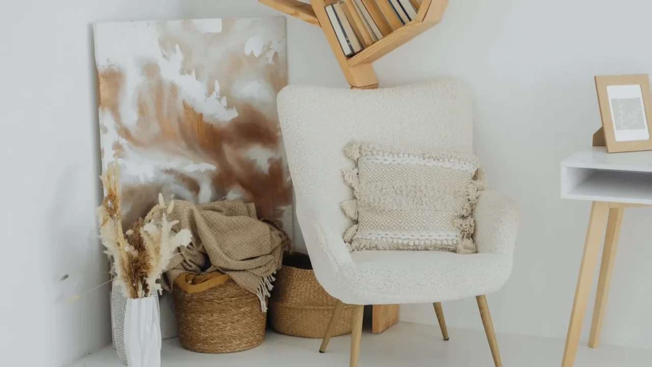 A calming workspace showcases a comfortable chair beside artistic decor. Woven storage baskets on the floor.