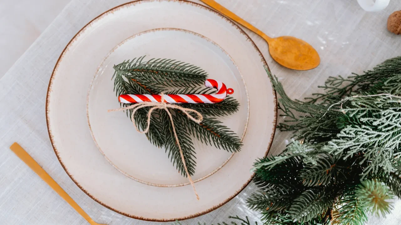 a festive table is set for the holidays featuring a