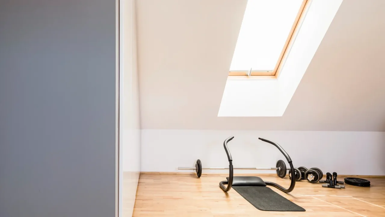 athletic equipment on wooden floor in home gym interior in