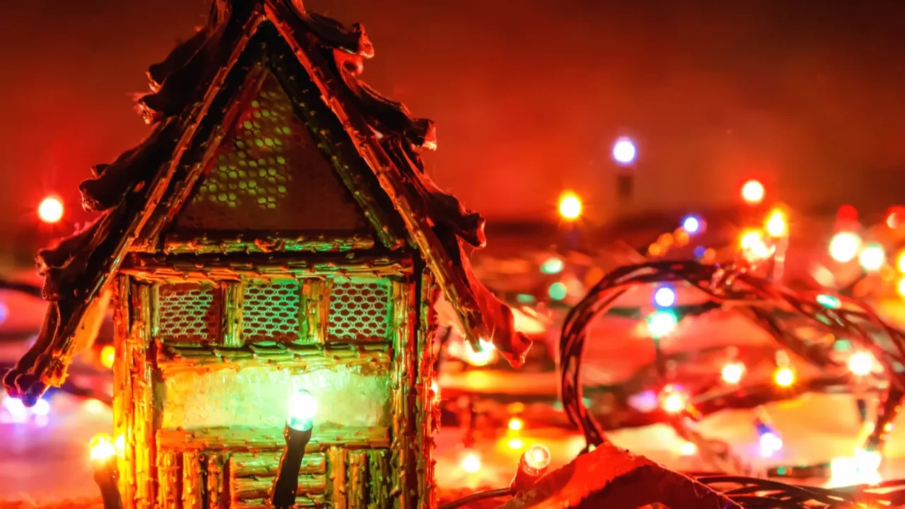 A beautiful Christmas background wooden house stands on a wooden background