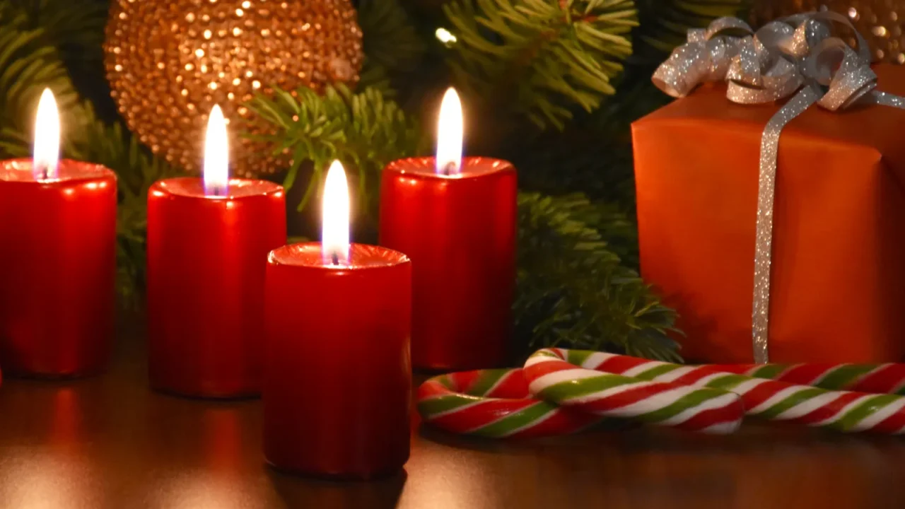 beautiful christmas decoration with burning red candles and gift box