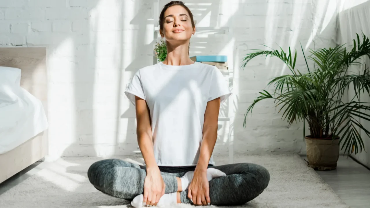 beautiful happy girl with closed eyes practicing yoga in lotus