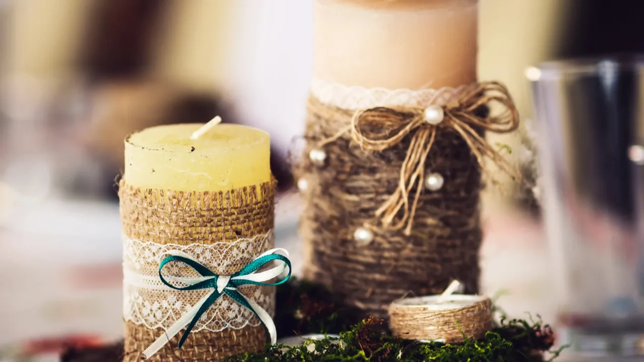 candles wrapped in burlap and decorated with a bowknot lace